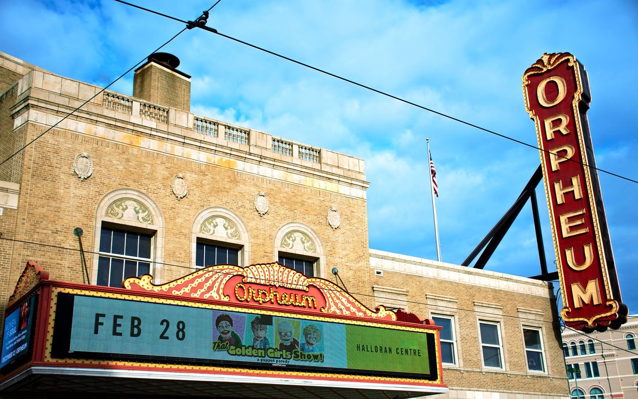 The Orpheum Theatre in downtown Memphis, with its ornate marquee and tall red-and-gold sign.