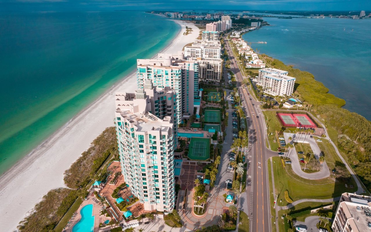 High-rise beachfront condominiums along Gulf Shore Boulevard in Park Shore, Naples Florida with turquoise Gulf waters and white sand beach
