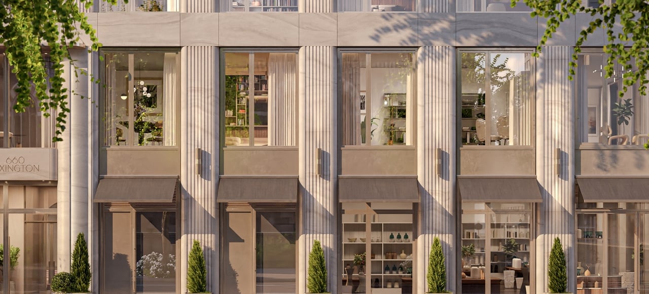 660 Lexington’s stone-clad facade with fluted columns, retail windows, and dark awnings.