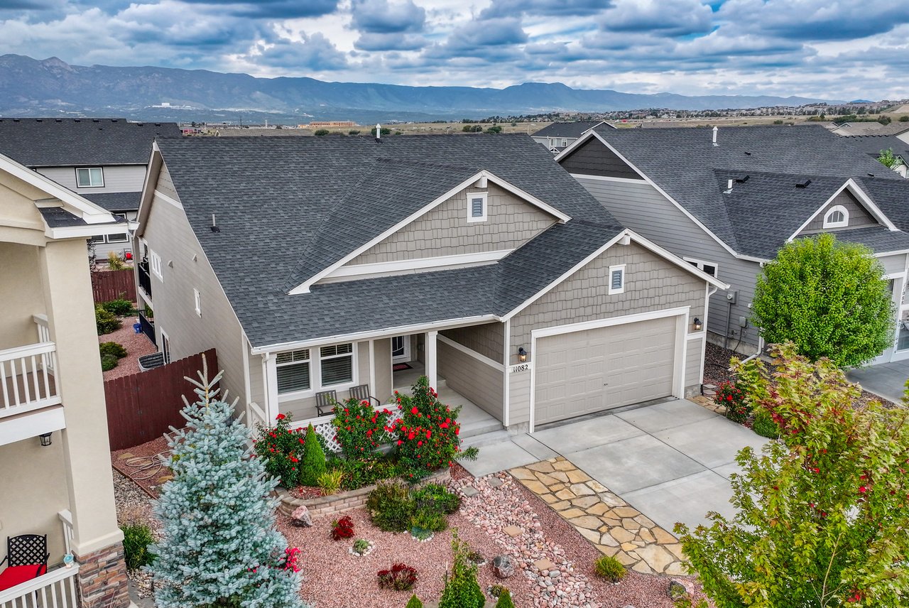 Aerial view of 11082 Falling Snow Lane with the Front Range mountains behind