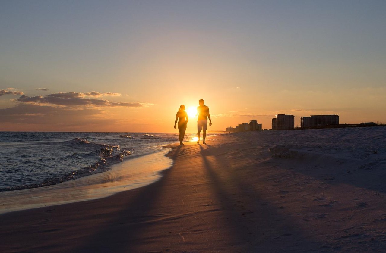 Couple enjoying a romantic sunset overlooking the Tampa Bay skyline, showcasing the beautiful waterfront lifestyle in Tampa Bay