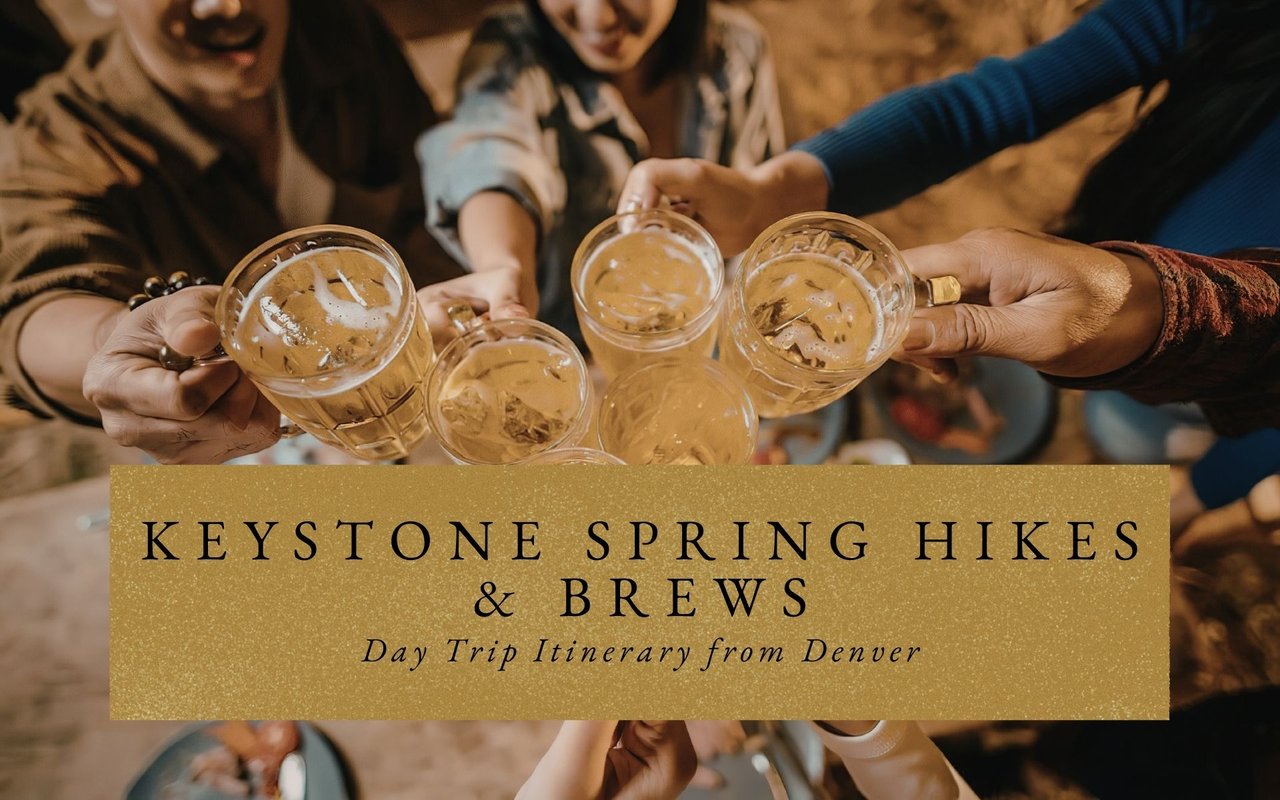 Friends clinking beer glasses on Keystone Village brewery patio with Tenmile Range mountains glowing at sunset