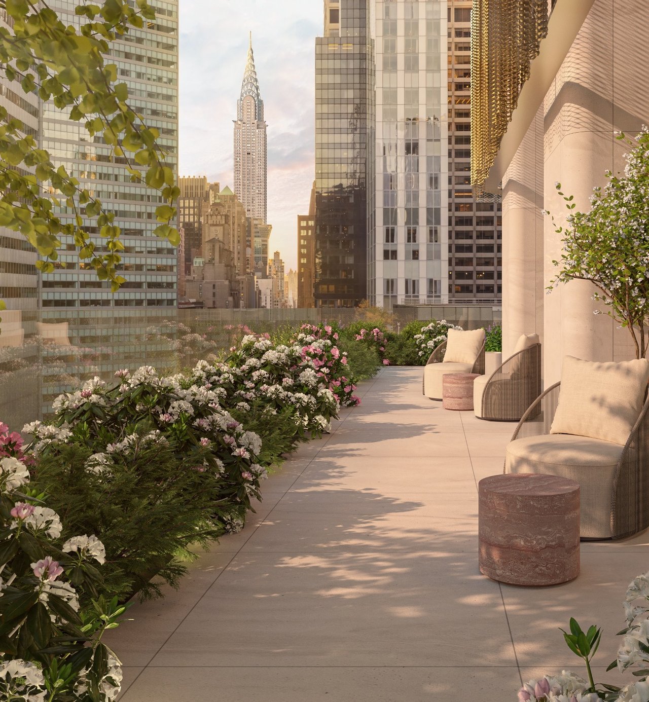 Landscaped terrace with lounge seating and flowering gardens overlooking the Chrysler Building.