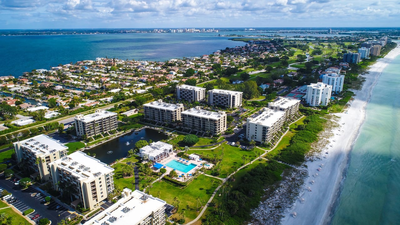 Longboat Key beachfront condominiums, landscaped grounds, and pool beside the Gulf beach.