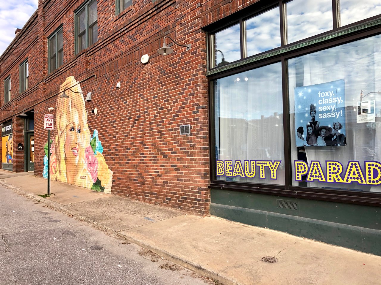Brick Wall with Dolly Parton Mural and Local Business Window