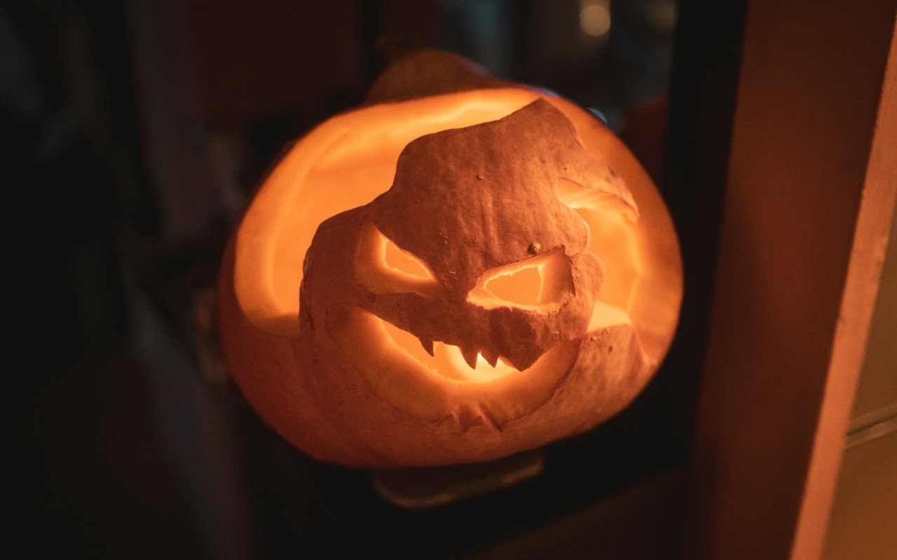A glowing, carved pumpkin with a menacing face.