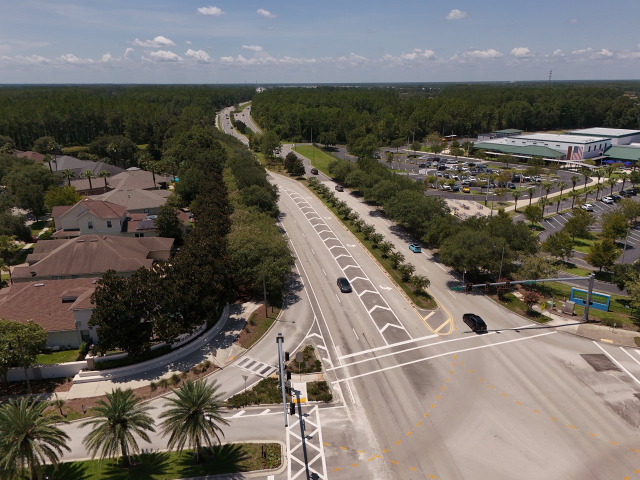 Aerial view of homes and a shopping center beside a divided road in Nocatee.