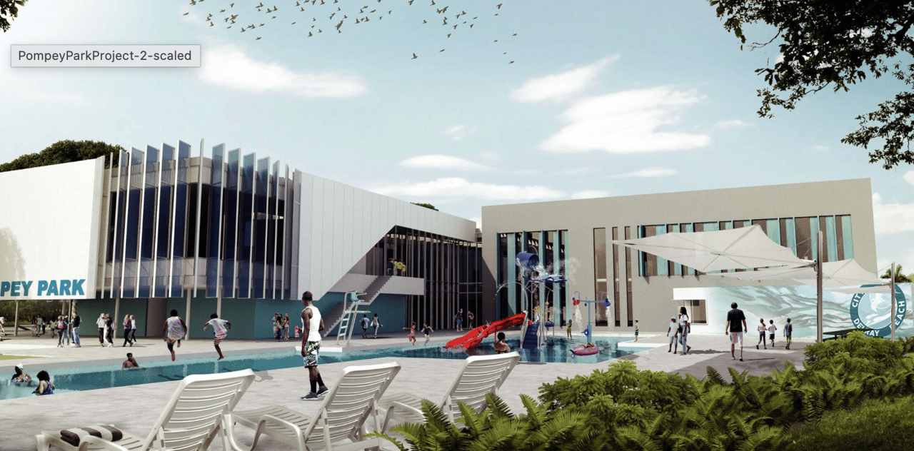 Pompey Park recreation complex with a modern aquatic center, pool, splash pad, and lounge chairs.