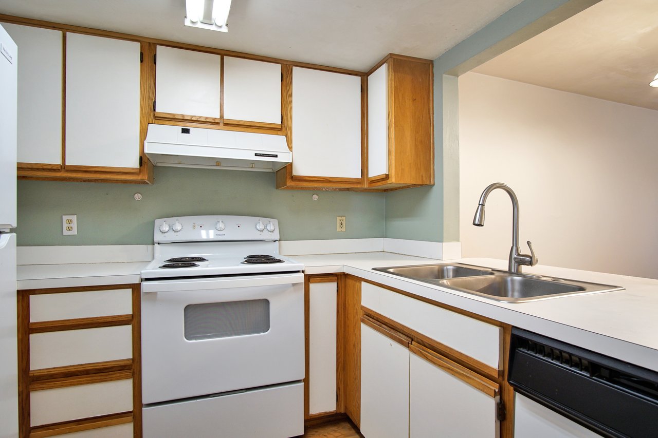 A modern kitchen featuring a sink, stove, and refrigerator, showcasing a functional and organized cooking space.