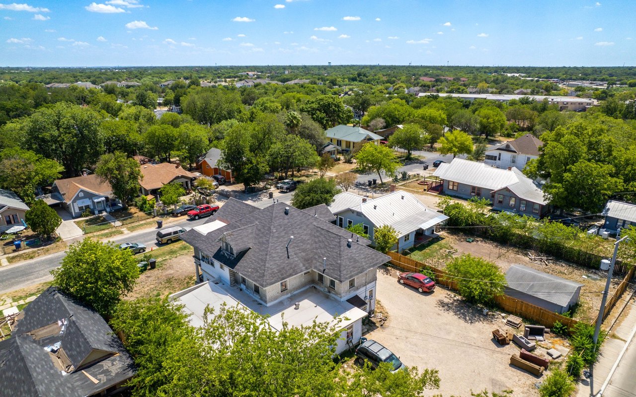 Aerial view of tree-lined residential streets and detached homes in Bryker Woods.