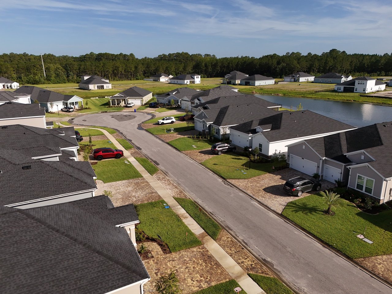 Aerial view of homes along a cul-de-sac beside a pond in Silver Falls.