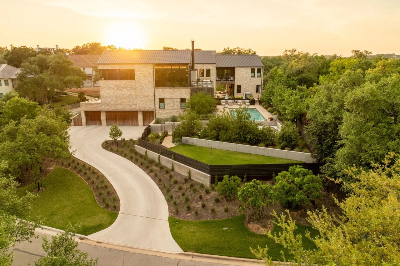A quiet, tree-lined residential street in the Rollingwood neighborhood of West Austin.