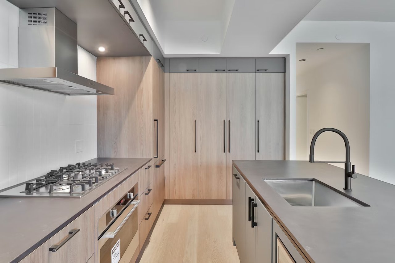 Luxury modern kitchen with warm wood tones representing strategic home preparation and market timing, curated by Amy Ali - Agency West