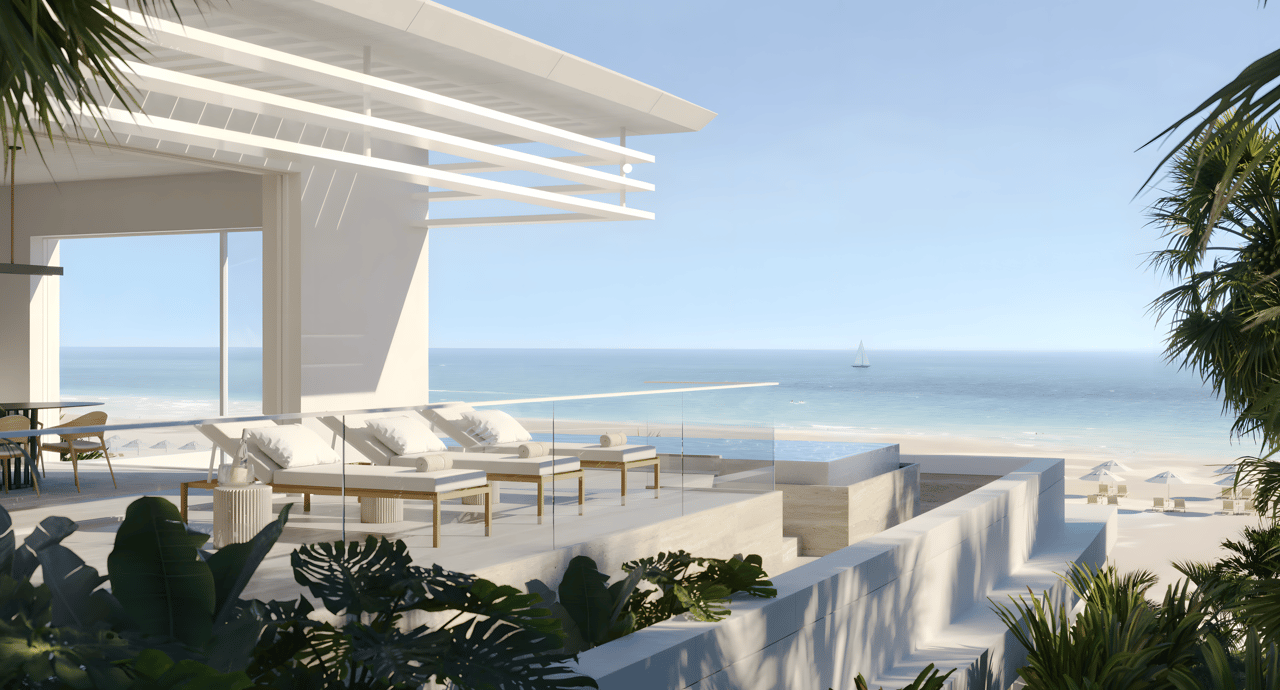 Modern beachfront terrace with lounge chairs and an infinity pool overlooking the ocean.