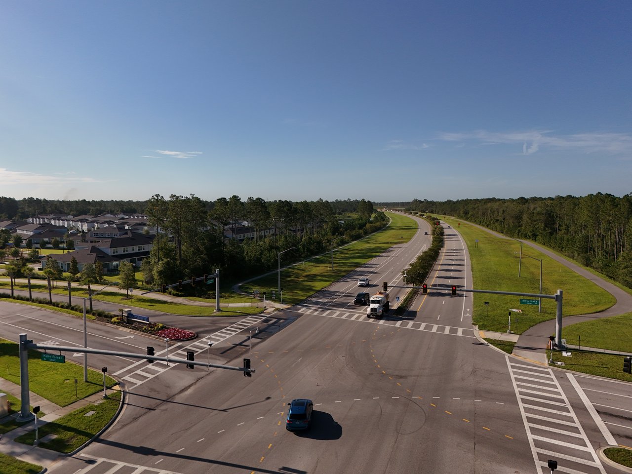 Aerial view of the Holly Forest area, with homes beside a divided road and a large intersection.