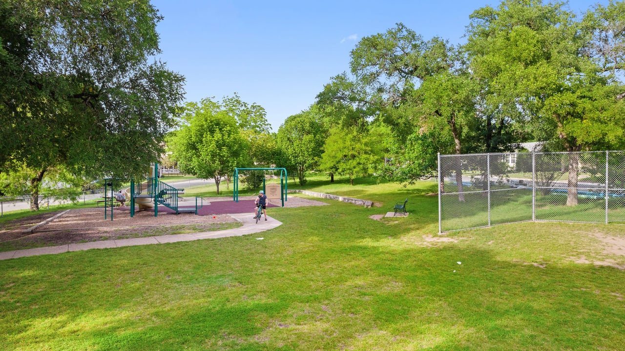 Neighborhood park with a fenced play area near 34 Margranita Crescent, Tarrytown, Austin, TX.