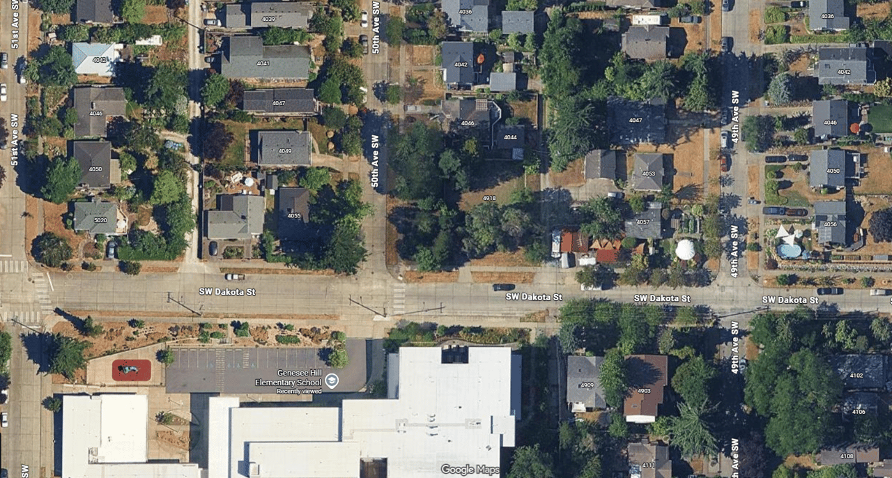Google Maps view of SW Dakota St and 50th Ave SW showing empty lot next to Genesee Hill Elementary