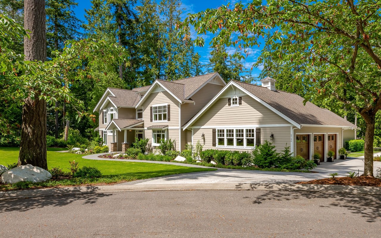 College Meadows home with multiple gables, a three-car garage, and mature trees.