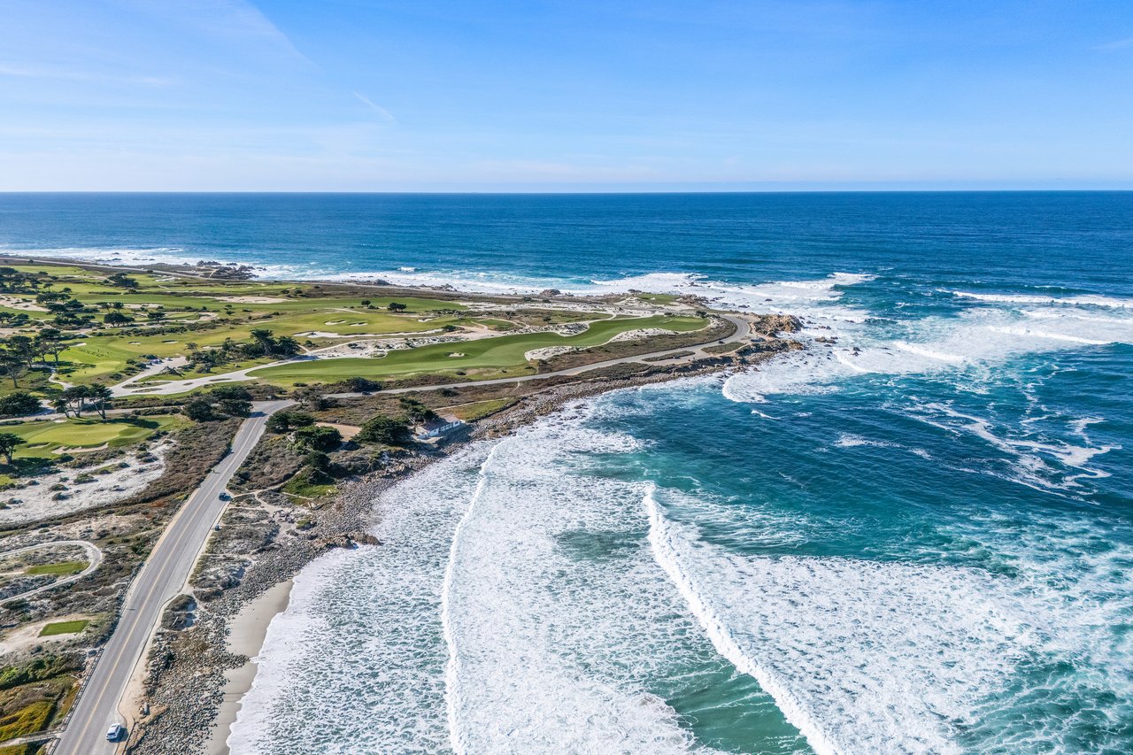 Aerial view of Pebble Beach Golf Links and Point Joe, with 17-Mile Drive winding along rocky coastline and crashing waves.