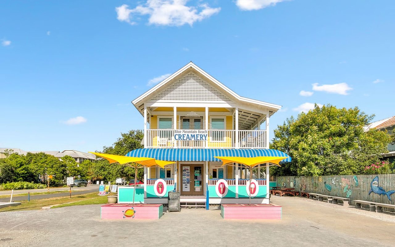 Blue Mountain Beach Creamery with a striped awning and colorful outdoor seating.