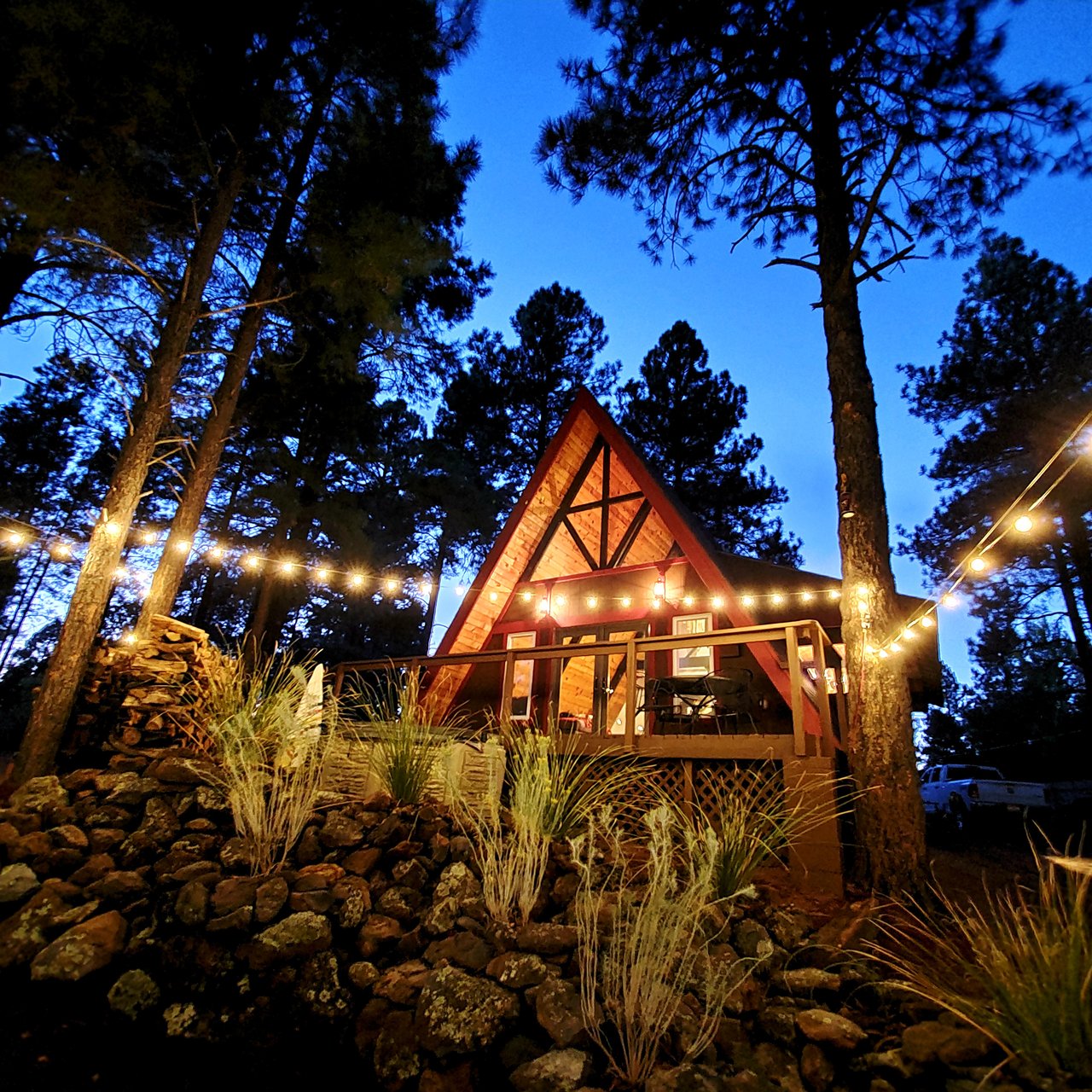 Aframe home with outdoor lights in the evening