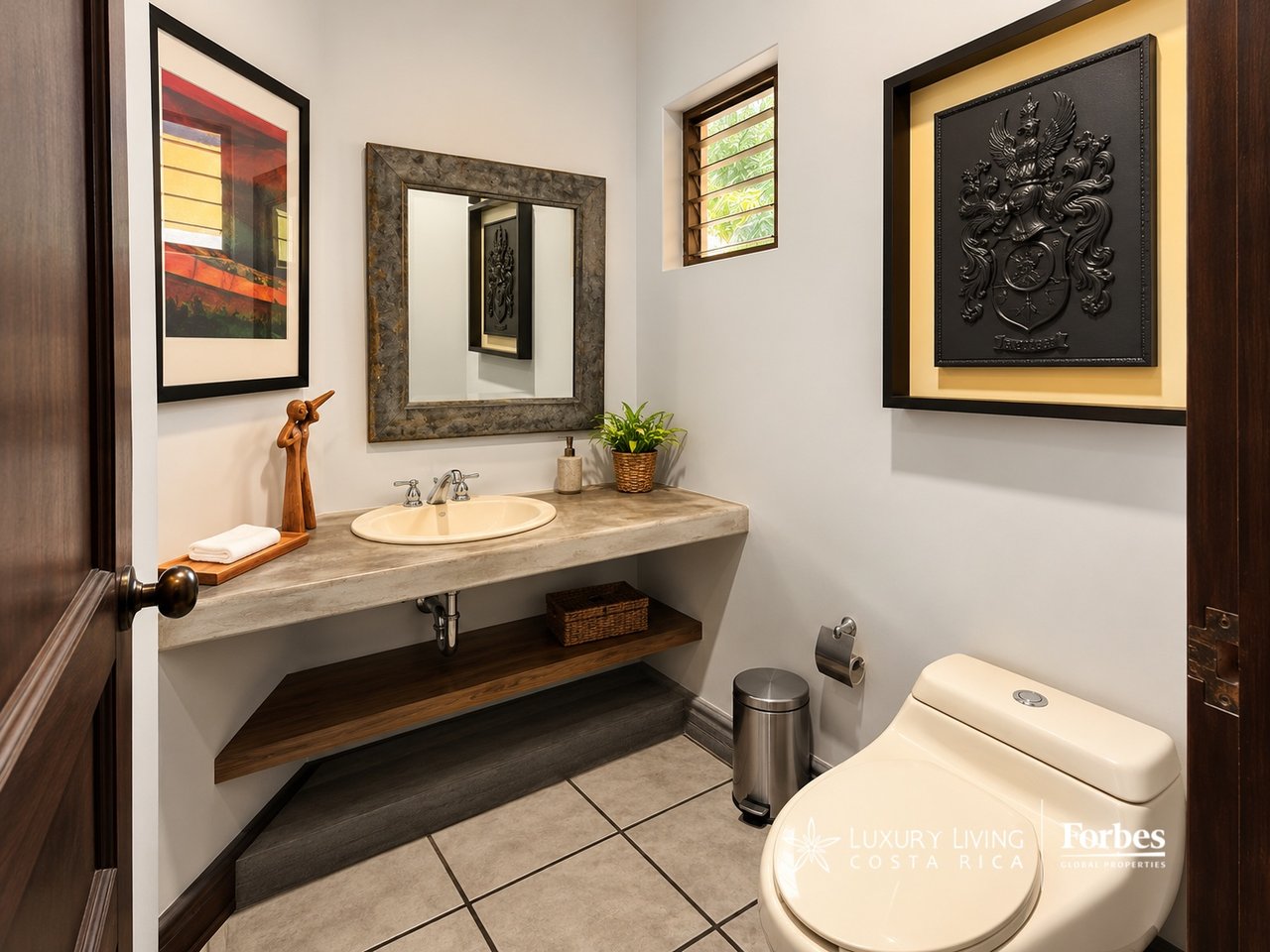 Bathroom with a stone-look vanity, framed mirror, and decorative black wall art.