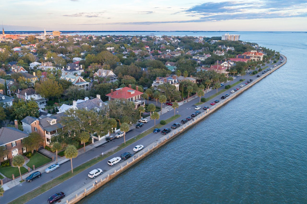 Charleston SC aerial showing waterfront mansions and the Battery at sunset
