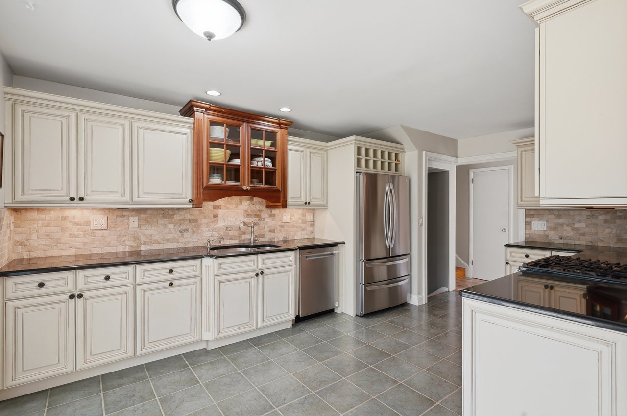 Roomy kitchen with granite countertops and under-lit cabinets