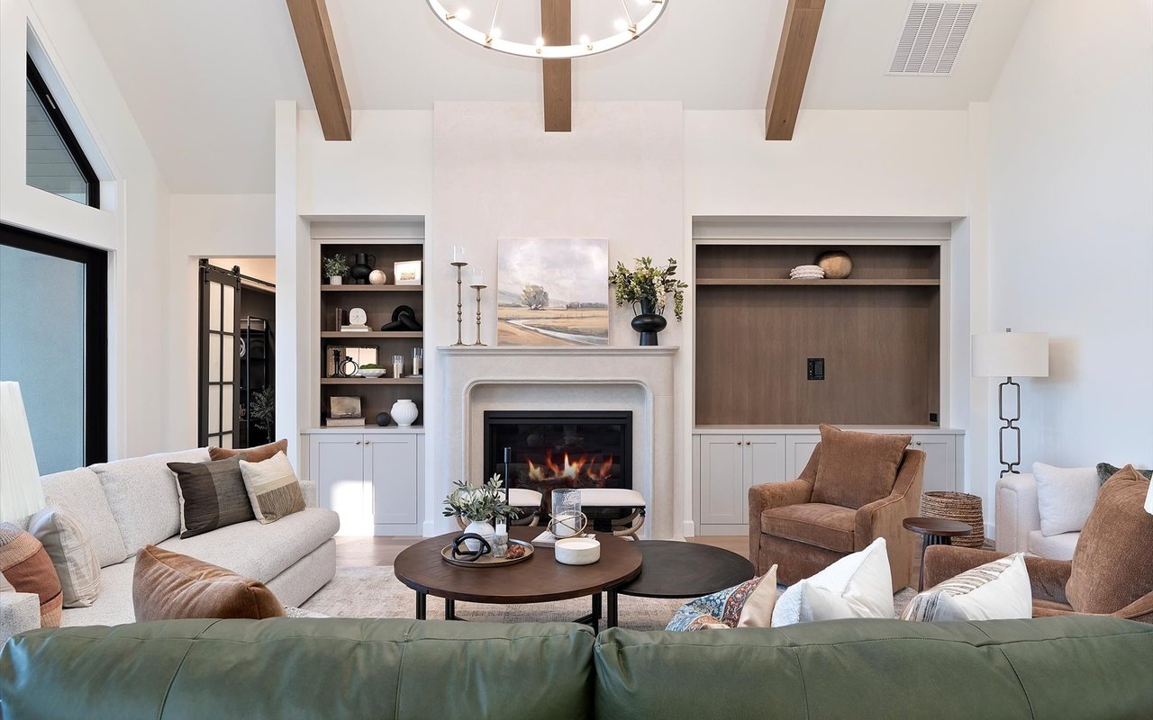 Living room wall with gas fireplace, traditional mantel, and built-in cabinets