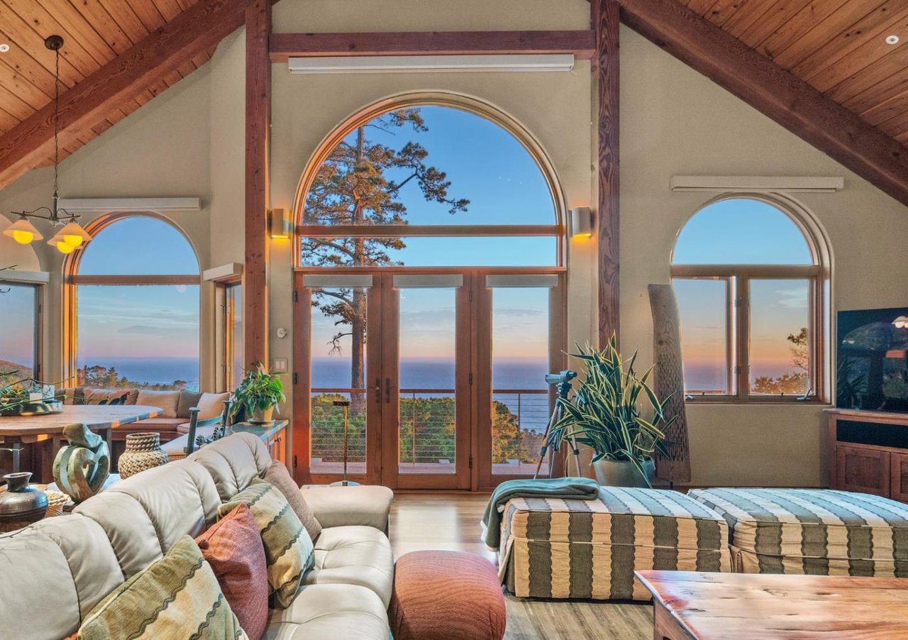 Living room with vaulted timber ceilings and ocean views in $5.5M Carmel Highlands home for sale