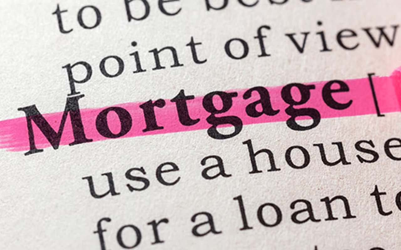 The word “Mortgage” highlighted in pink on a printed page.