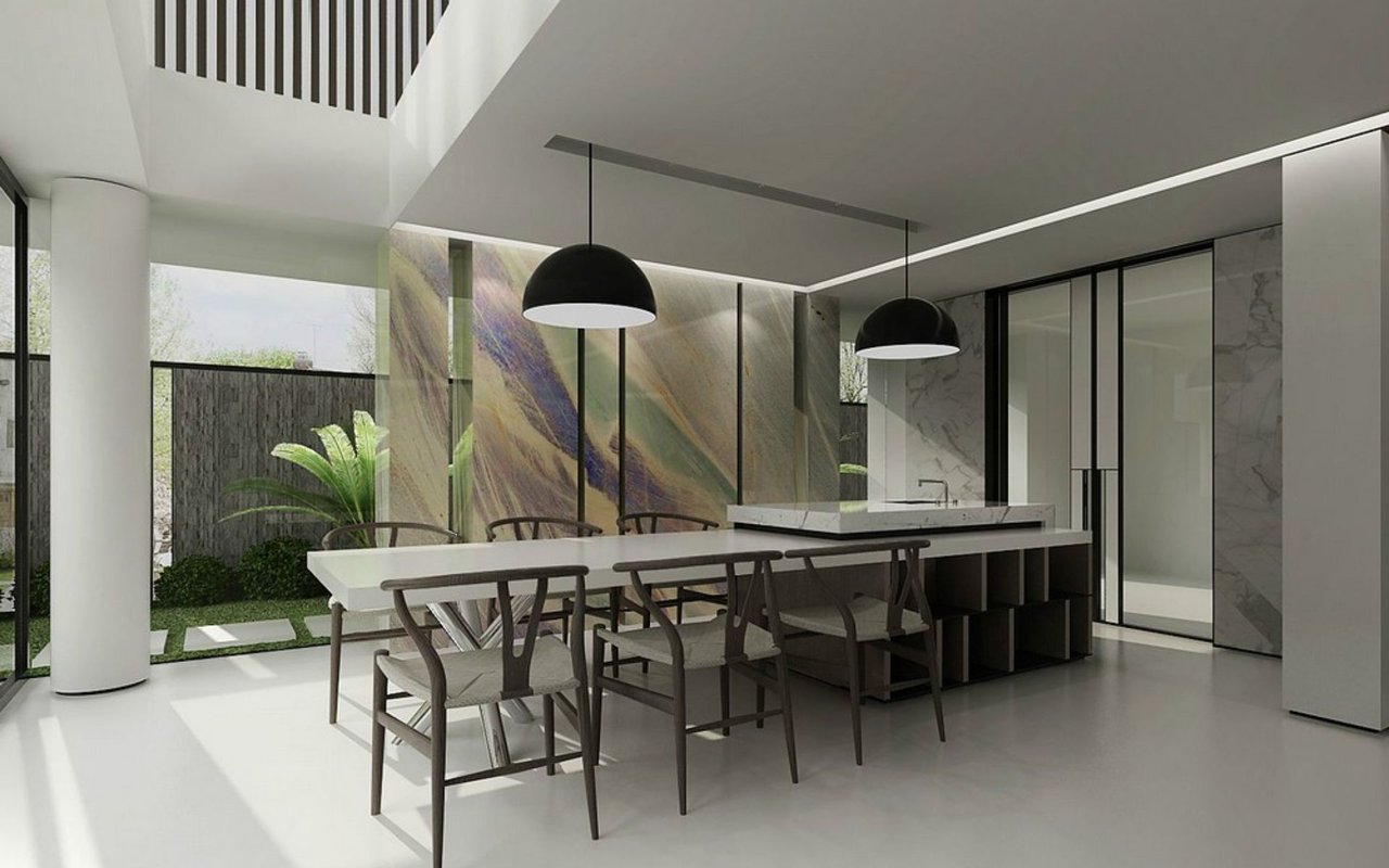 A kitchen island with a sink, featuring a light-colored countertop and dark open shelving below, extends from a wall adorned with a striking, colorful marble-like panel.