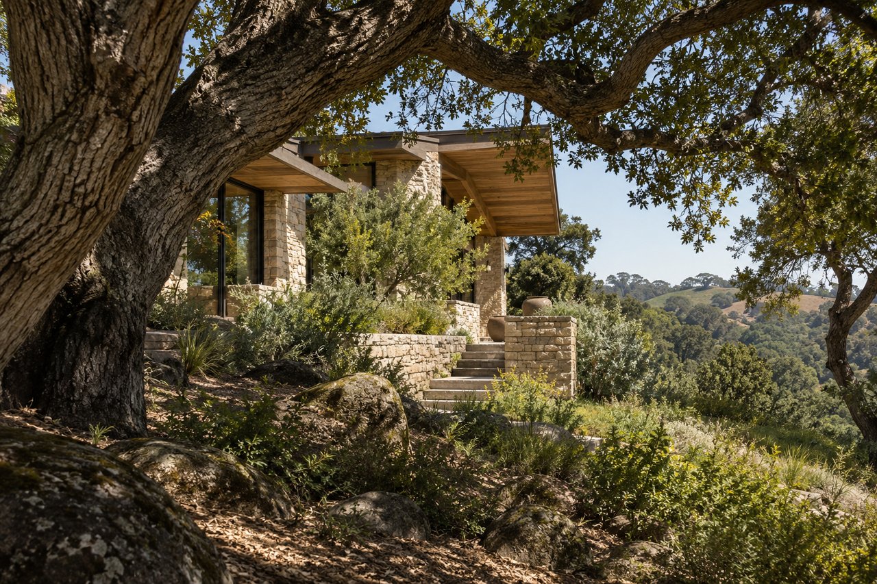 Custom masonry, mature trees, and a carefully integrated residence demonstrate how architecture and site can create a distinctive high-end property.