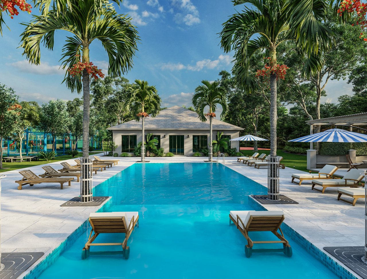 Windsor Lakes community pool and clubhouse surrounded by palm trees in Nassau, Bahamas