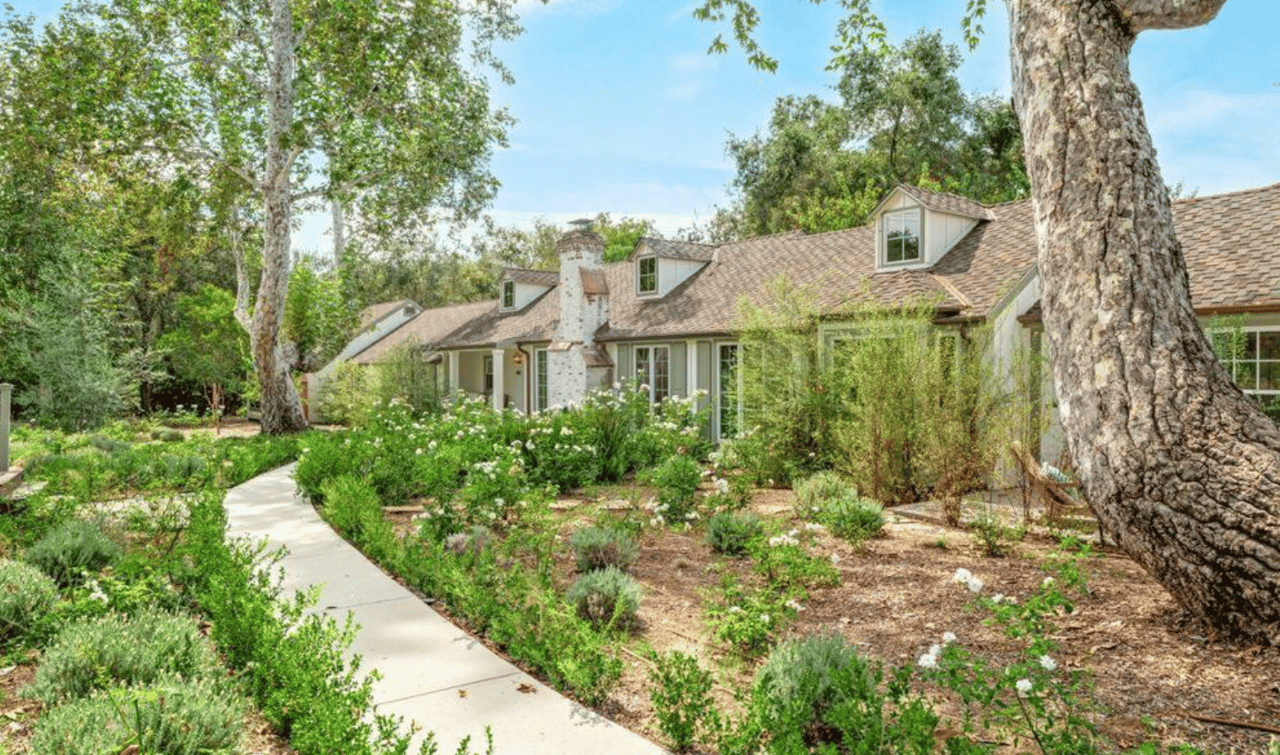 An Ojai valley property with orange groves and the Topatopa Mountains behind it.