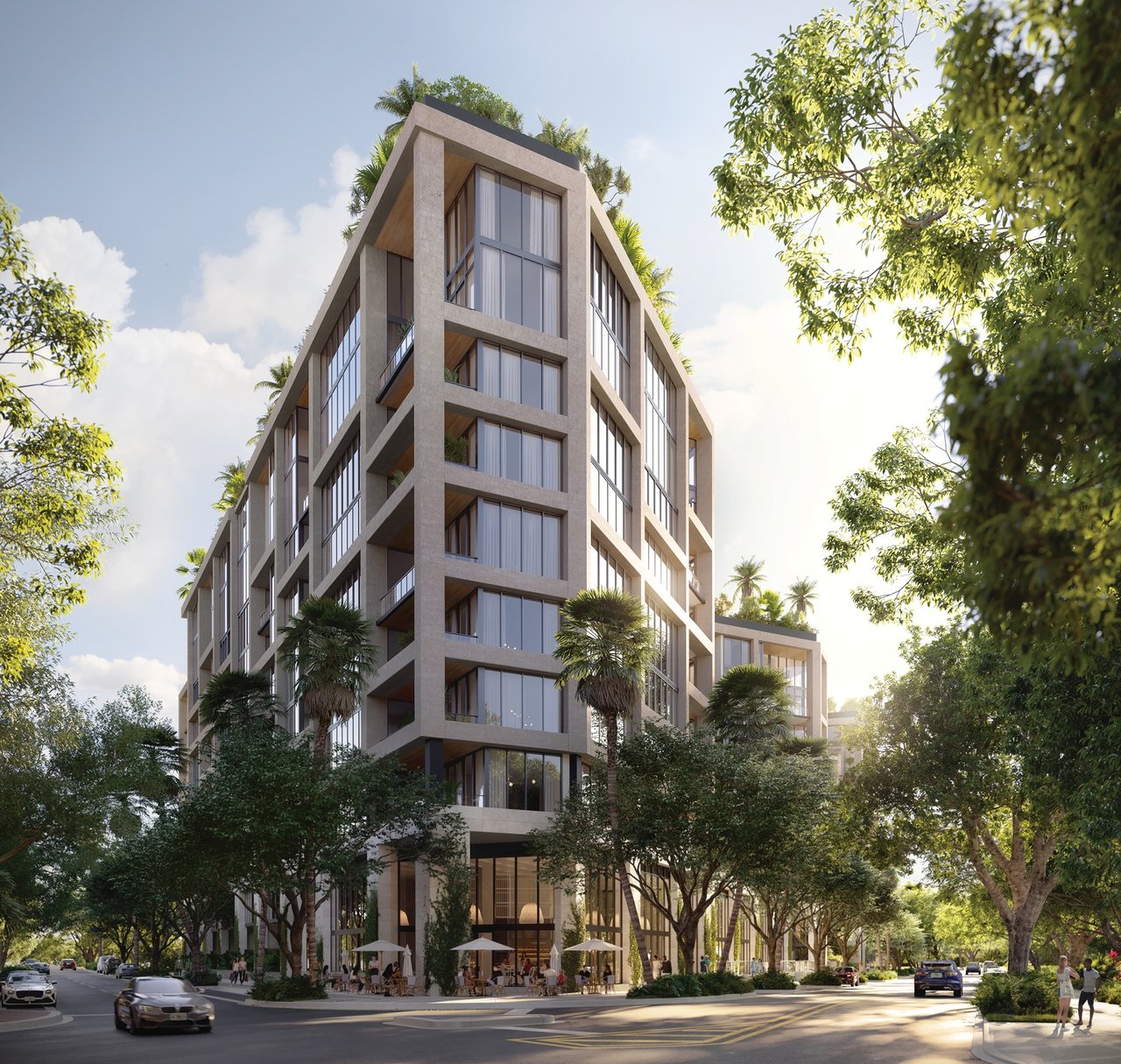 THE WELL Coconut Grove residential tower framed by tropical trees, with balconies and a street-level café terrace.
