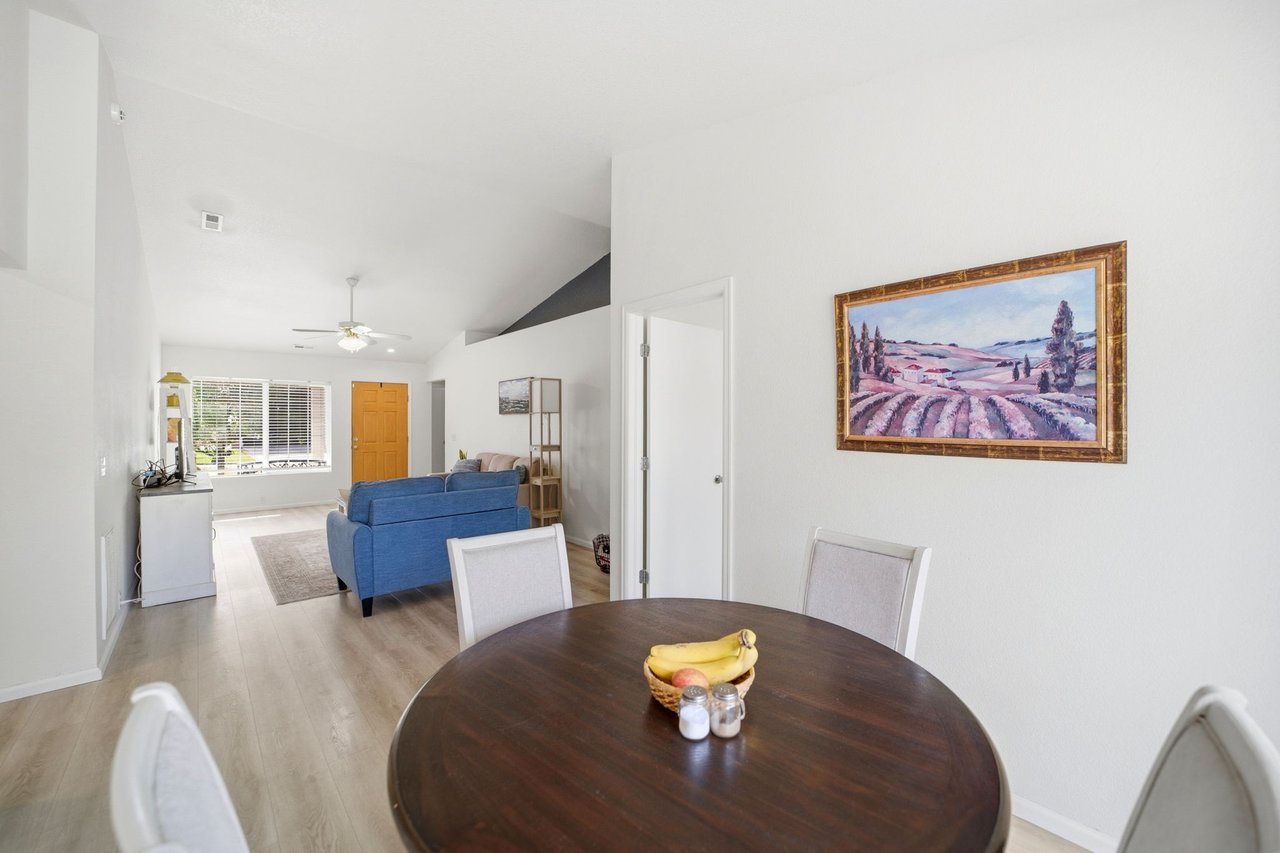 Dining area with vaulted ceiling open to the living room and front entry