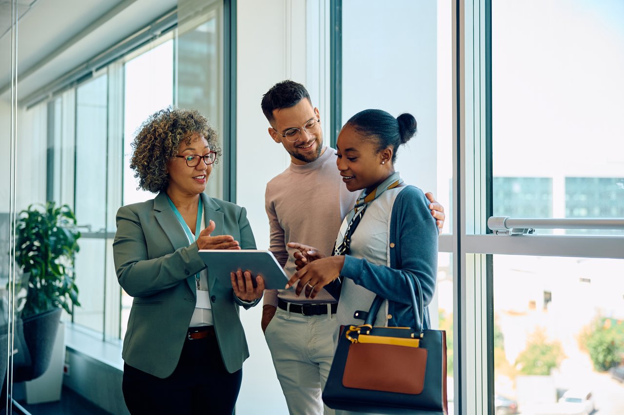 Diverse real estate professionals reviewing listings together in a bright office setting