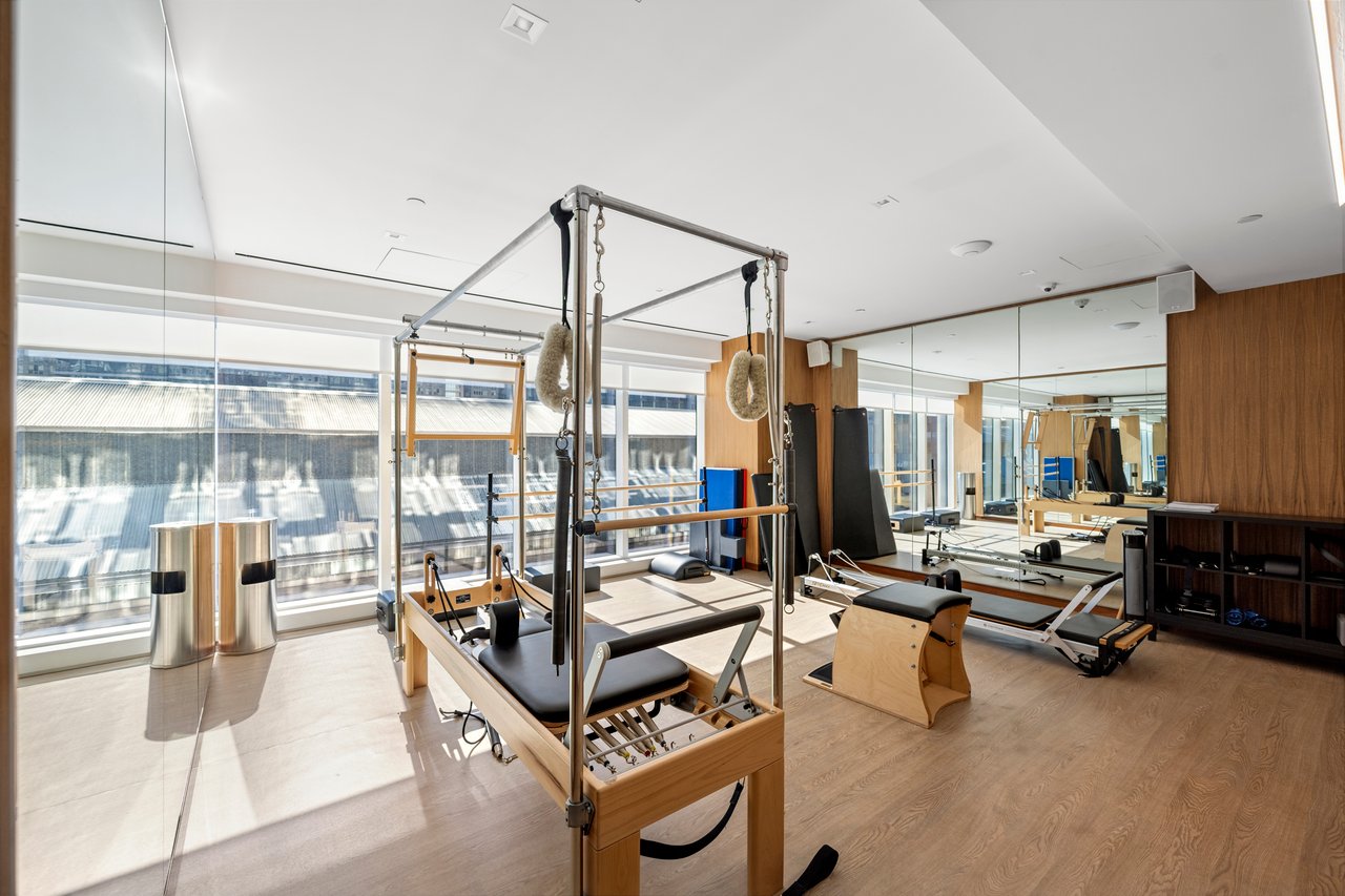 Luxury Manhattan condominium wellness amenities including an indoor swimming pool, spa, sauna, steam room, fitness center, yoga studio, massage room, and landscaped outdoor spaces.