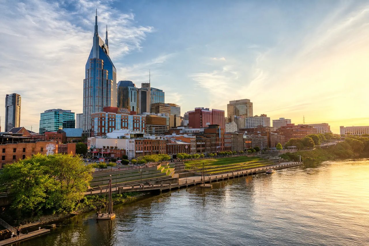Young professionals walking through a lively Nashville neighborhood with apartments, restaurants, coffee shops, and the downtown skyline nearby.