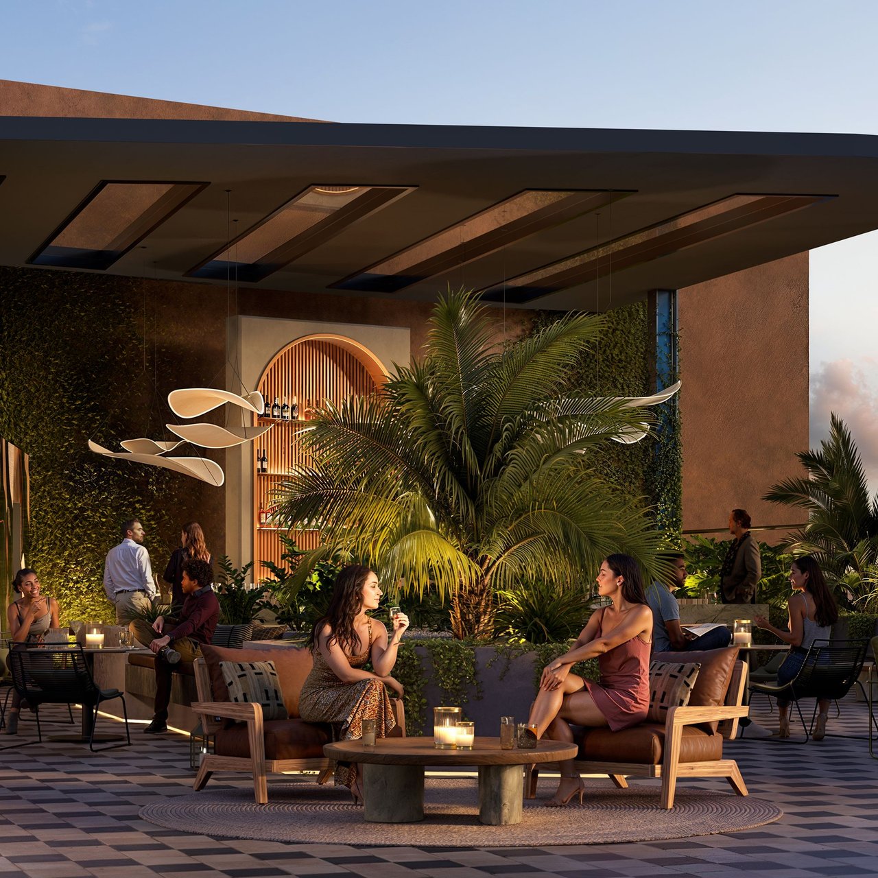 Rooftop terrace with tropical plants, sculptural canopy, and residents gathered around lounge seating.