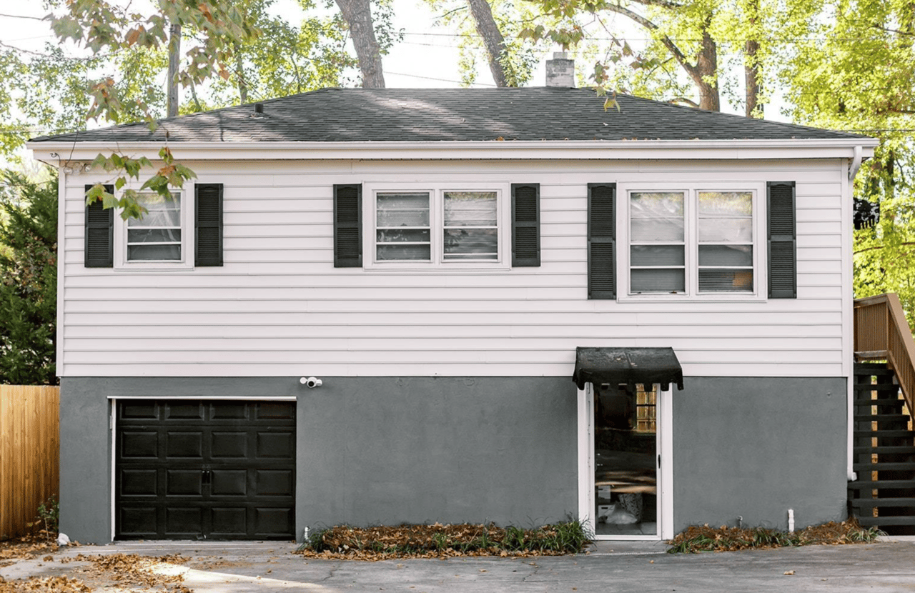 Exterior of carriage house with two apartments and one-car garage behind main home.