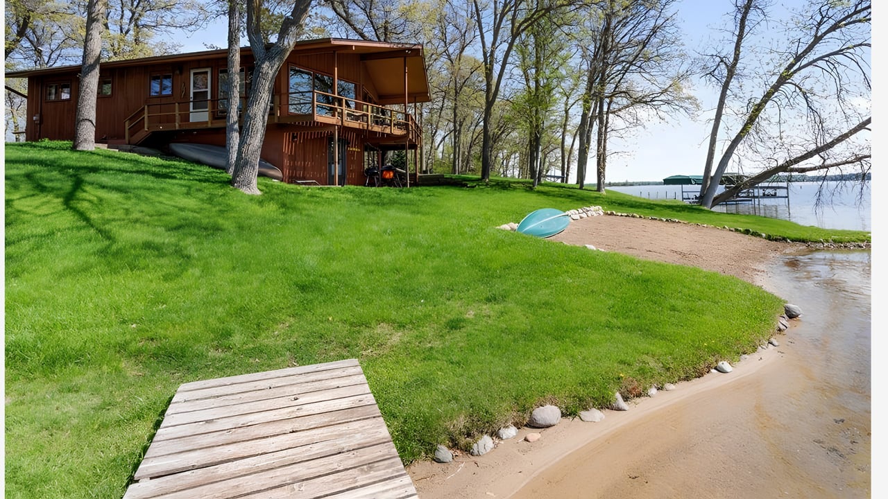 Brainerd Lakes lake home with dock and calm water before summer