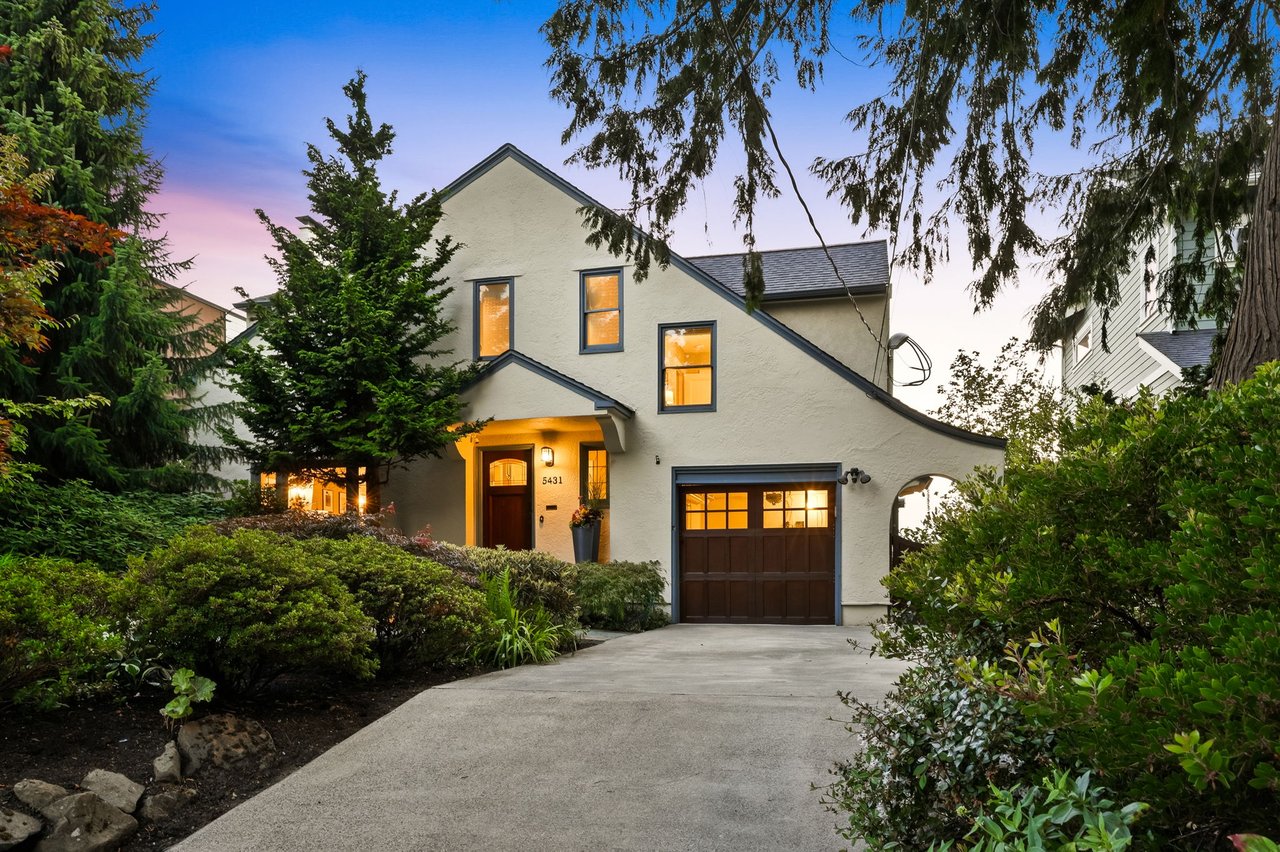 Twilight exterior of a 1926 French Tudor home at 5431 49th Ave SW in Seaview, West Seattle