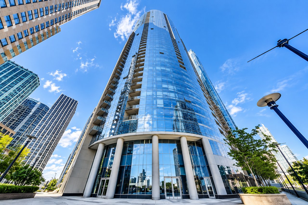 The Regatta condominium tower at 420 E Waterside Drive in Chicago's Lakeshore East neighborhood, featuring its distinctive curved glass façade."
