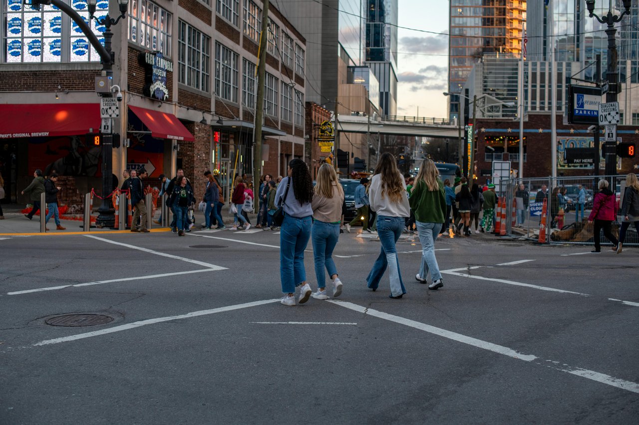 Pedestrians crossing at Broadway and 5th Ave near Glen Campbell Museum in downtown Nashville