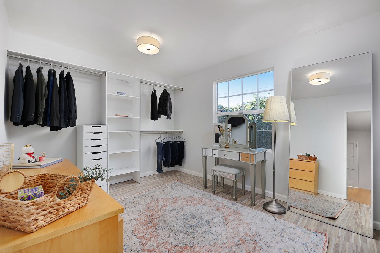 Custom closet system and makeup vanity with large mirror in secondary bedroom or flex space