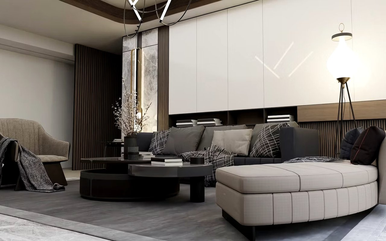 Modern living room with a gray sectional, curved cream ottoman, and dark wood accent wall.