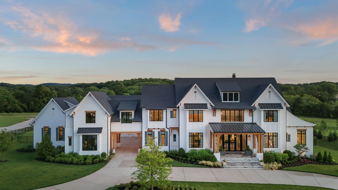 Brentwood Tennessee luxury estate home with rolling hills, manicured landscaping, large lot, and scenic sunset views.
