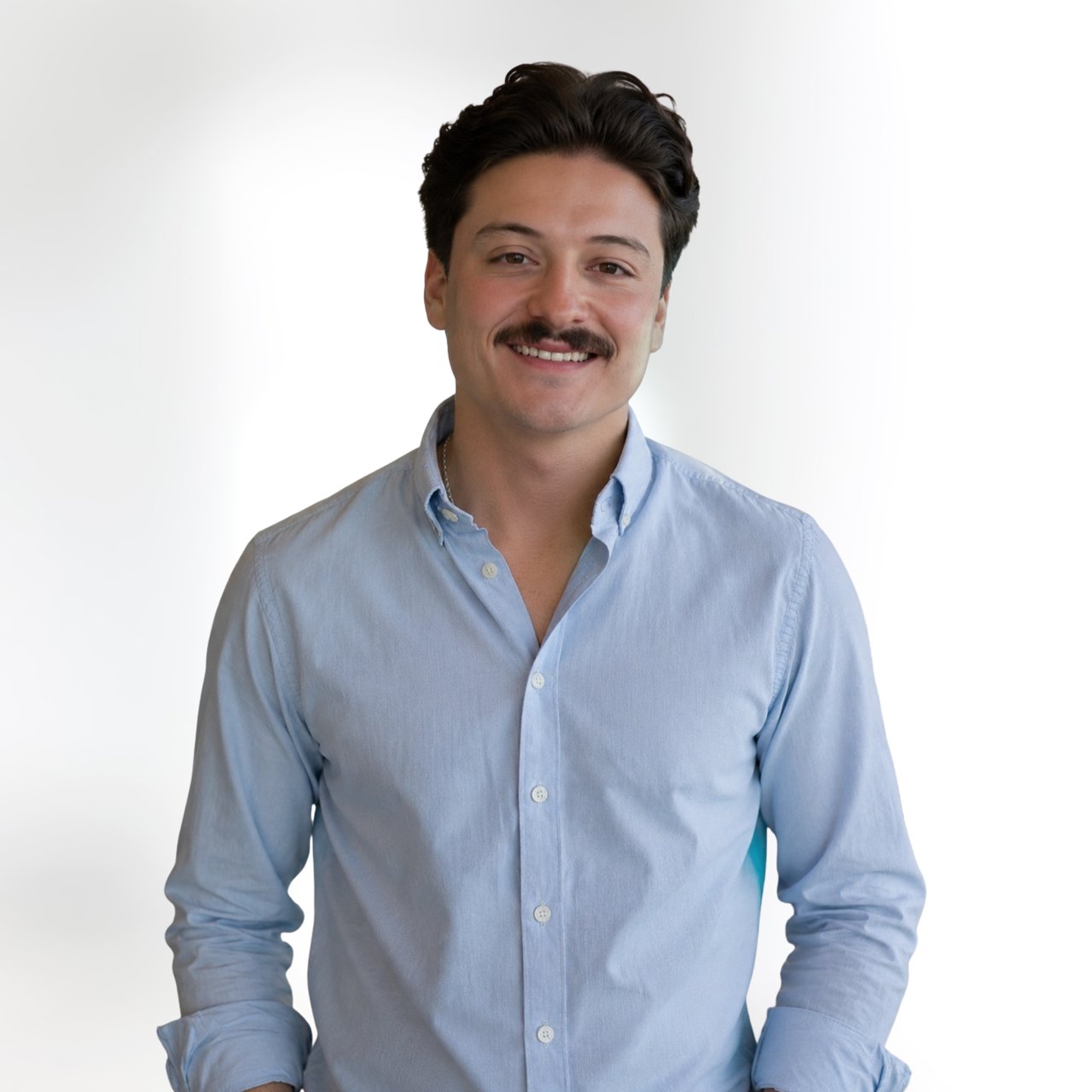 Jaden Rivera smiling in a light blue button-down shirt.